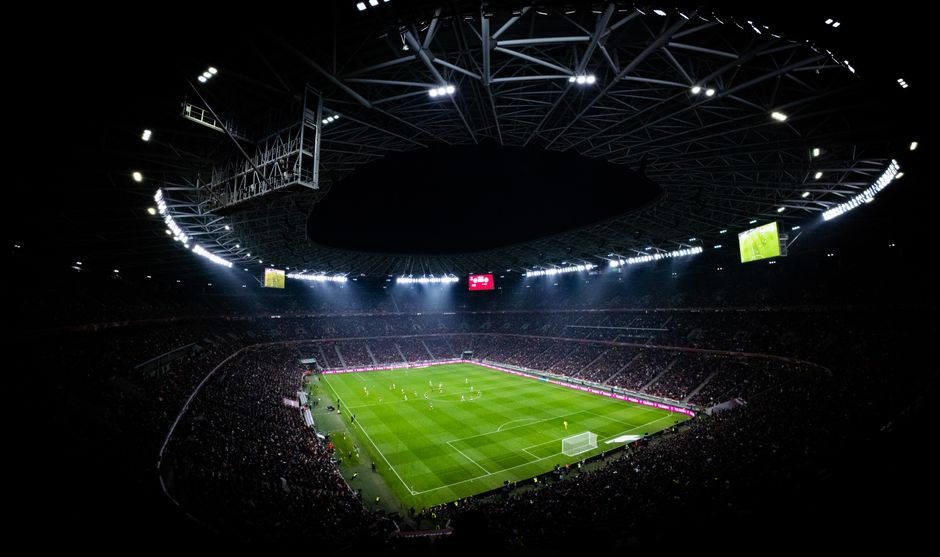 Football match under stadium floodlights