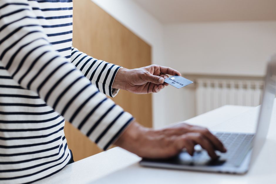 Person entering card details on a laptop