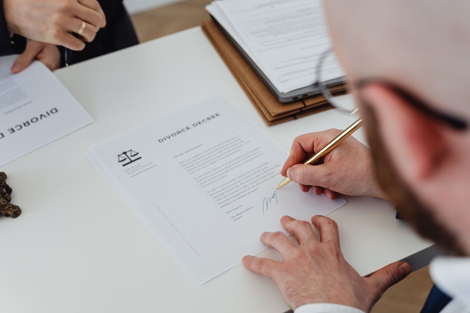 Contract documents and a pen on a desk