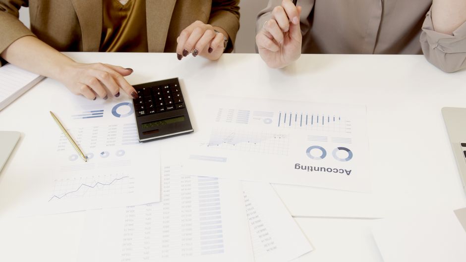 Calculator and printed figures on a desk
