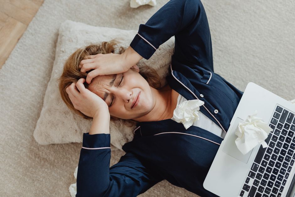Person holding a remote control at home