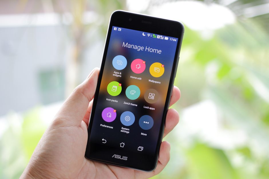 Person holding an Android smartphone navigating an application interface