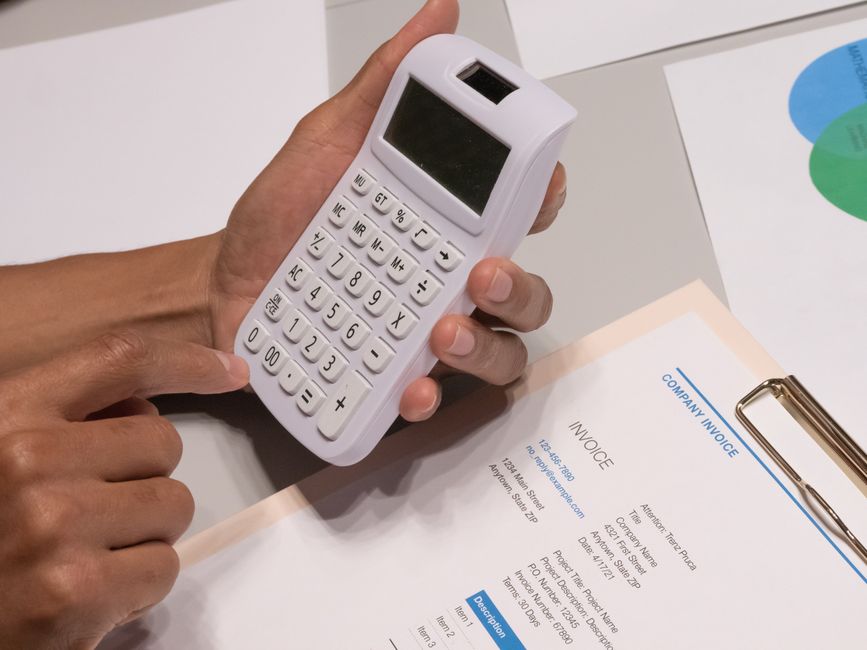Calculator and invoice on a desk